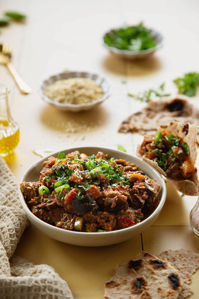 Aubergine stew with flat bread, roti, in the backlight.