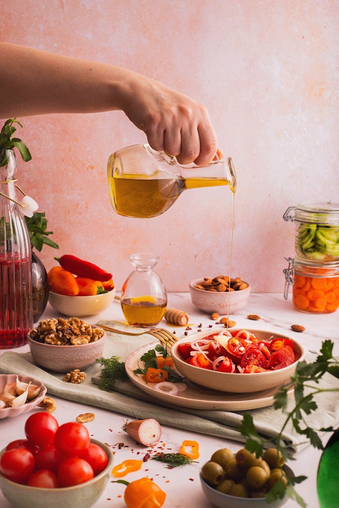 Mediterranean tomato salad with olives, vegetables, and olive oil.