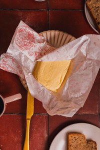 Freshly made butter in the wrapping paper.