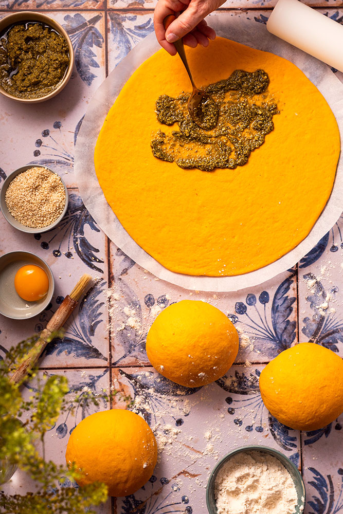 Festive pumpkin/butternut squash star brioche style bread with pesto sprinkled sesame seeds, process shot.