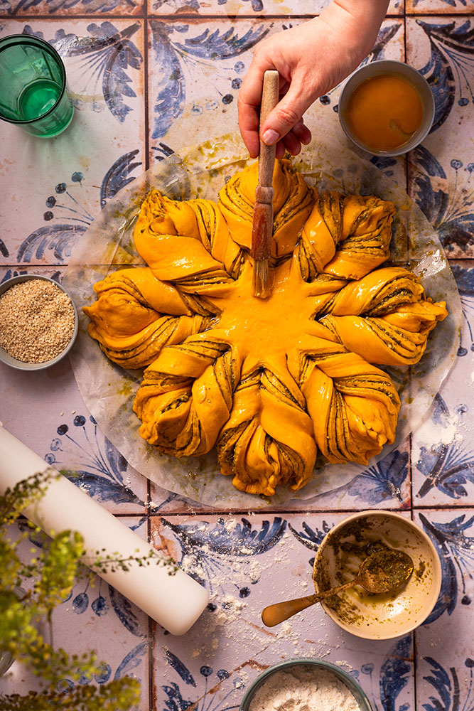 Festive pumpkin/butternut squash star brioche style bread with pesto sprinkled sesame seeds, process shot.