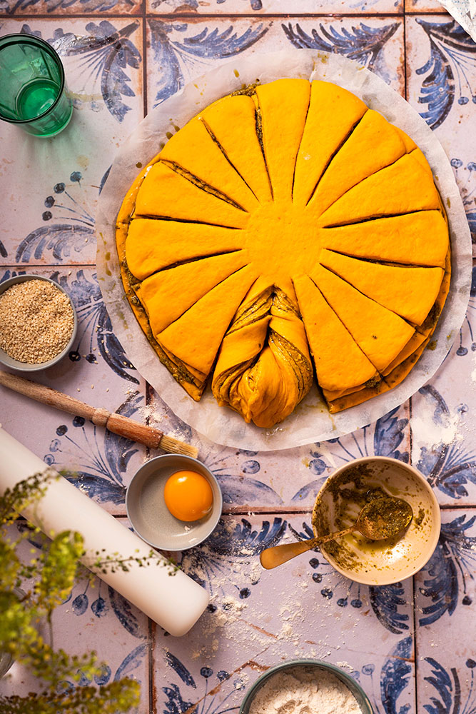 Festive pumpkin/butternut squash star brioche style bread with pesto sprinkled sesame seeds, process shot.