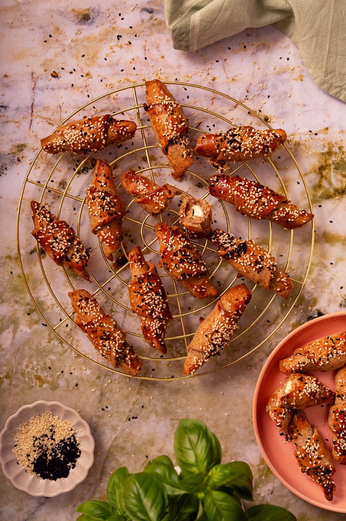 Wholemeal pastry crescent rolls with feta cheese filling and sesame seeds sprinkle. Freshly baked. 