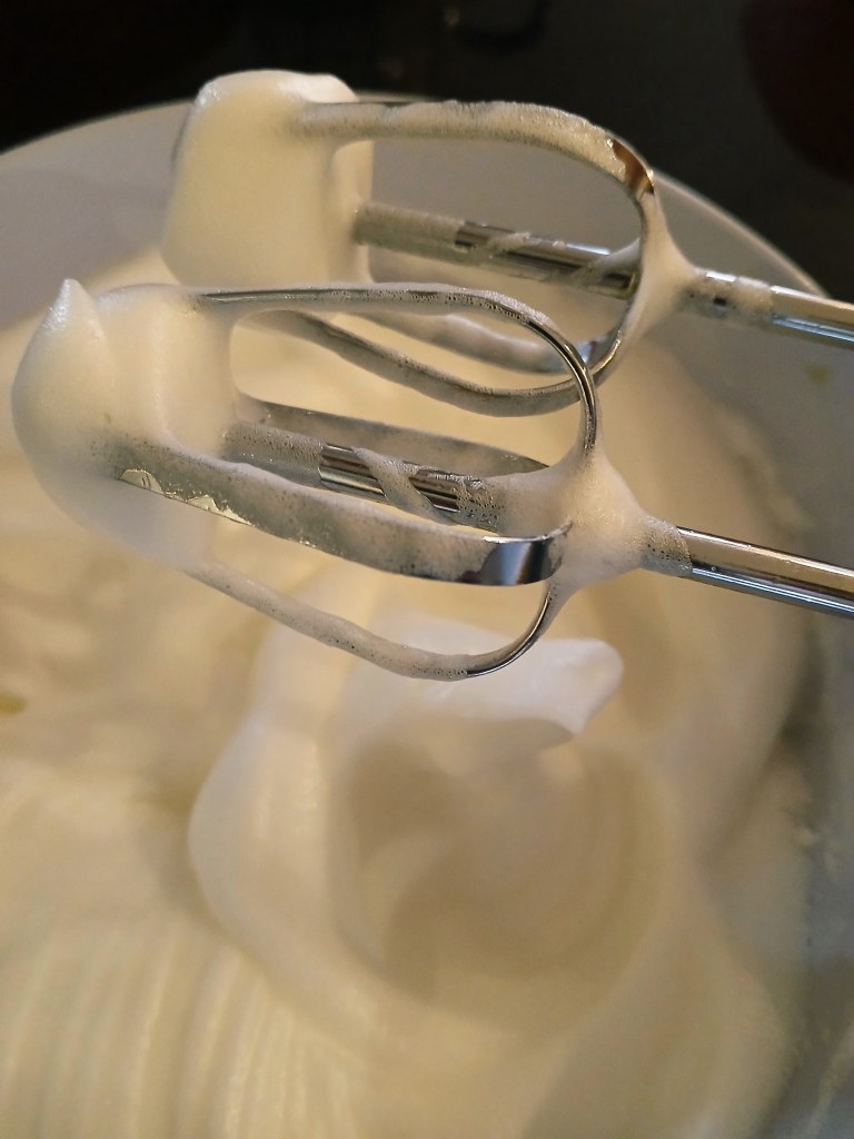 Torte of walnut dacquoise layered with vanilla and chocolate crème mousseline, whisked egg whites.