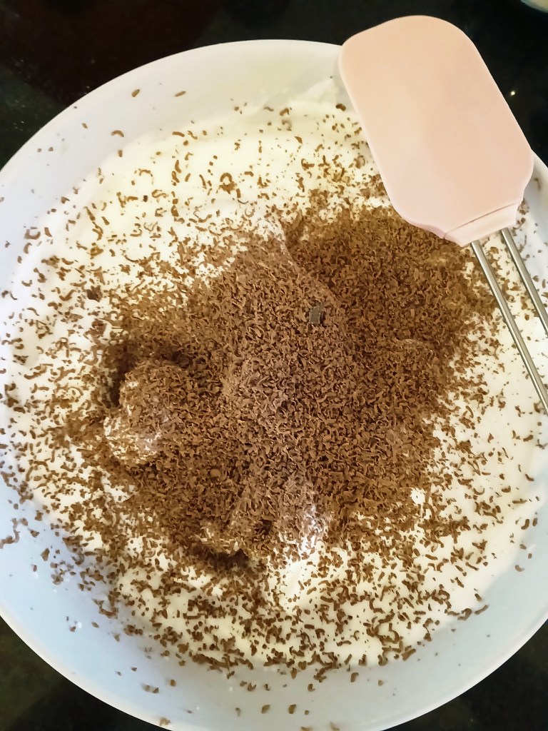 Torte of walnut dacquoise layered with vanilla and chocolate crème mousseline, whisked egg whites.