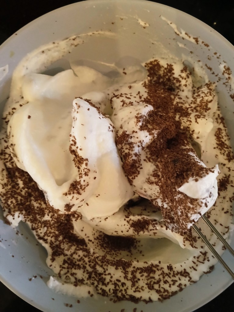 Torte of walnut dacquoise layered with vanilla and chocolate crème mousseline, whisked egg whites.