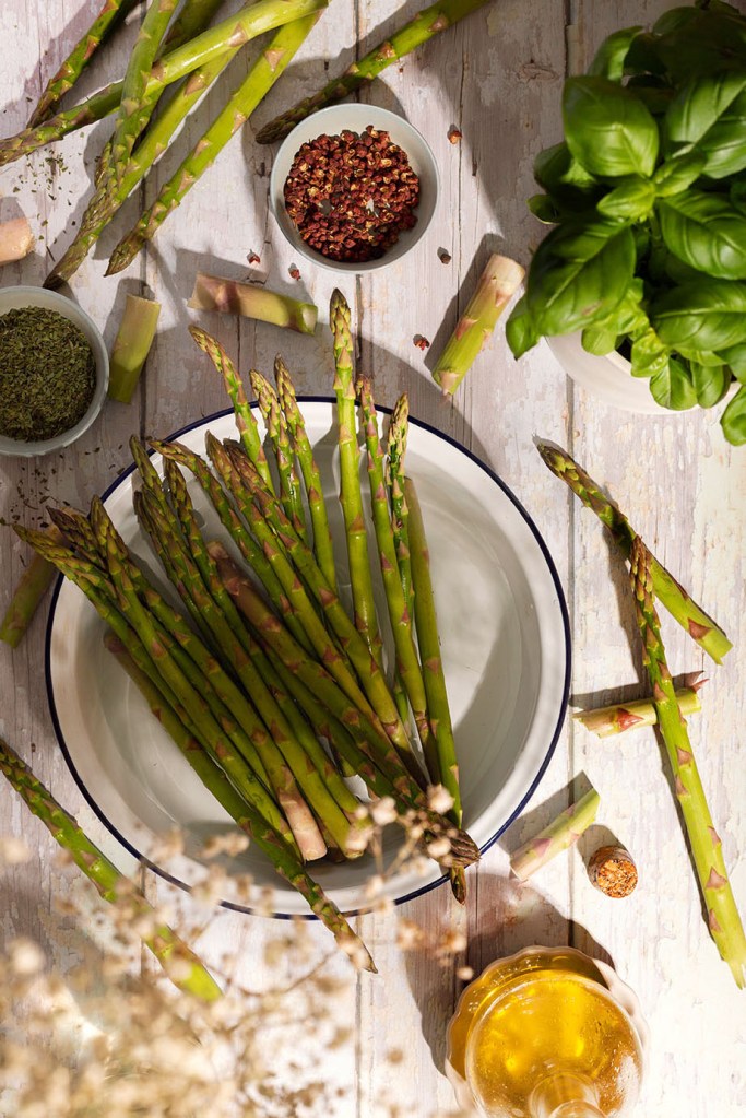 Asparagus and Feta Cheese Tart with Wholemeal Crust-asparagus on the table in the sunlight. 