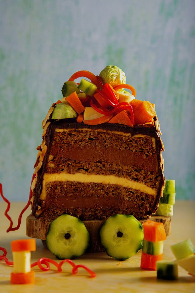 Slice of torte decorated with vegetables.